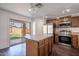 Modern kitchen with island, stainless appliances, and sliding glass door to a private backyard at 1202 W Central Ave, Coolidge, AZ 85128