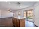 Kitchen island with dark wood cabinets adjacent to sliding glass doors and living room at 1202 W Central Ave, Coolidge, AZ 85128