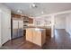 Kitchen featuring wood cabinets, stainless steel appliances, and island open to living area at 1202 W Central Ave, Coolidge, AZ 85128