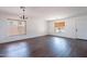 Bright living room featuring wood floors, neutral walls, and natural light through large windows at 1202 W Central Ave, Coolidge, AZ 85128