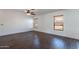 Empty room with wood floors, ceiling fan, baseboards, and window with wood blinds at 1202 W Central Ave, Coolidge, AZ 85128