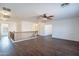 Second-floor living room with wood floors and staircase leading to bedrooms and baths at 1202 W Central Ave, Coolidge, AZ 85128