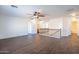 Spacious living room with ceiling fan and wood floors leading to staircase and bedrooms at 1202 W Central Ave, Coolidge, AZ 85128