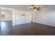 Empty living room with wood floors, ceiling fan, baseboards, and doorway at 1202 W Central Ave, Coolidge, AZ 85128