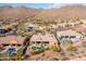 Panoramic aerial of desert home featuring a pool, spa, and landscaped backyard at 12083 E Wethersfield Dr, Scottsdale, AZ 85259