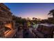 Inviting outdoor space with fireplace, seating, and a view of the pool and waterfall at 12083 E Wethersfield Dr, Scottsdale, AZ 85259