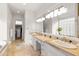 Bright bathroom with dual sinks, marble countertops, and a soaking tub at 12083 E Wethersfield Dr, Scottsdale, AZ 85259