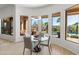 Dining room with a modern chandelier and views of the outdoor patio at 12083 E Wethersfield Dr, Scottsdale, AZ 85259