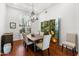 Charming dining room featuring wood floors, shutters, and decorative chandelier at 12083 E Wethersfield Dr, Scottsdale, AZ 85259