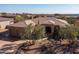 Aerial view of a desert home with a well-manicured front yard and mature trees at 12083 E Wethersfield Dr, Scottsdale, AZ 85259