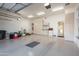 Well-organized garage with ample storage cabinets, shelving, and a clean epoxy floor at 12083 E Wethersfield Dr, Scottsdale, AZ 85259