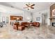 Spacious living room with leather furniture, stone fireplace, and travertine floors at 12083 E Wethersfield Dr, Scottsdale, AZ 85259