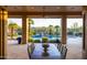 Outdoor dining area with a view of the backyard pool and waterfall at 12083 E Wethersfield Dr, Scottsdale, AZ 85259