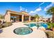 Inviting backyard pool and spa area with lush desert landscaping and an outdoor kitchen at 12083 E Wethersfield Dr, Scottsdale, AZ 85259