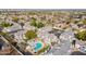 High aerial view of residential neighborhood featuring a community pool, manicured lawns, and well-maintained roofs at 1222 W Baseline Rd # 116, Tempe, AZ 85283