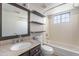 Bathroom with updated granite vanity, framed mirror, tub/shower, toilet, and floating shelves for storage at 1222 W Baseline Rd # 116, Tempe, AZ 85283