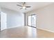 Bright, airy bedroom with a sliding glass door to a patio, neutral walls, tile floor, and ceiling fan at 1222 W Baseline Rd # 116, Tempe, AZ 85283