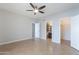 Spacious bedroom boasting neutral colors, tile flooring, ceiling fan, and ensuite bathroom with large closet at 1222 W Baseline Rd # 116, Tempe, AZ 85283