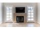 Elegant fireplace in living room flanked by doors leading to patio at 1222 W Baseline Rd # 116, Tempe, AZ 85283