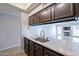 The kitchen features light countertops and stainless steel sink overlooking a Gathering room with fireplace at 1222 W Baseline Rd # 116, Tempe, AZ 85283