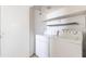 A bright laundry room is equipped with a washer, a dryer, and a shelf above at 1222 W Baseline Rd # 116, Tempe, AZ 85283