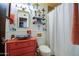 Vibrant bathroom features a unique vessel sink on a red vanity and eclectic decor, adding a personal touch to the space at 1340 E Townley Ave, Phoenix, AZ 85020