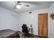 This bedroom includes wood-look flooring, a ceiling fan, a closet with wooden doors, and lots of natural light at 1340 E Townley Ave, Phoenix, AZ 85020