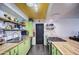 Open kitchen featuring a butcher block island, stylish cabinets, and stainless steel appliances at 1340 E Townley Ave, Phoenix, AZ 85020