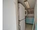 This laundry area features a stacked washer and dryer and built-in shelving, providing a convenient and organized space for laundry tasks at 1340 E Townley Ave, Phoenix, AZ 85020