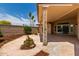 Backyard porch featuring decorative metal beam supports and mature landscaping at 13677 N 108Th Dr, Sun City, AZ 85351