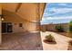 Covered back porch with decorative metal beam supports, sliding glass doors, and concrete patio at 13677 N 108Th Dr, Sun City, AZ 85351