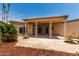 Back porch featuring decorative metal beam supports, mature landscaping, and sliding glass door at 13677 N 108Th Dr, Sun City, AZ 85351