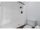 Bathroom with white shower, white toilet, and wood style flooring for a sleek, minimalist design at 13677 N 108Th Dr, Sun City, AZ 85351