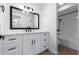 A modern bathroom with white cabinets, a quartz countertop, black hardware, and a shower/tub combination at 13677 N 108Th Dr, Sun City, AZ 85351