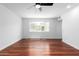 Bright bedroom features wood floors, a ceiling fan, neutral walls, and a large window at 13677 N 108Th Dr, Sun City, AZ 85351