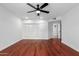 Bedroom with hardwood floors, ceiling fan, closet with built-in storage, and a clean, modern aesthetic at 13677 N 108Th Dr, Sun City, AZ 85351