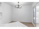 Dining area with modern chandelier, tile flooring, and a sliding glass door at 13677 N 108Th Dr, Sun City, AZ 85351