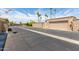 Exterior neighborhood shot with gated garages, palm trees, and blue sky at 13677 N 108Th Dr, Sun City, AZ 85351