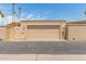 A tan garage door with brick and iron fence in a sunny area at 13677 N 108Th Dr, Sun City, AZ 85351