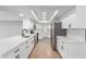 Modern kitchen featuring white cabinets, quartz countertops, stainless steel appliances, and a stylish black faucet at 13677 N 108Th Dr, Sun City, AZ 85351