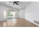 Bright living room boasts wood-look tile flooring, fresh paint, and a sliding glass door at 13677 N 108Th Dr, Sun City, AZ 85351