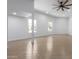 Bright living room boasts wood-look tile flooring, fresh paint, and a ceiling fan at 13677 N 108Th Dr, Sun City, AZ 85351