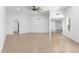 Large living room with wood-look tile, white walls, and recessed lighting throughout at 13677 N 108Th Dr, Sun City, AZ 85351