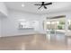 Open concept living room showcases breakfast bar, tile floors, and sliding glass doors to patio at 13677 N 108Th Dr, Sun City, AZ 85351