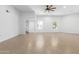 Spacious living room featuring tile floors, white walls, a ceiling fan, and ample natural light at 13677 N 108Th Dr, Sun City, AZ 85351