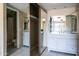 Bright bathroom with double sinks, vanity, and a mirrored closet at 1432 W Emerald Ave # 712, Mesa, AZ 85202