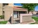 Charming condo exterior shows front entrance, private gate and brick trim at 1432 W Emerald Ave # 712, Mesa, AZ 85202