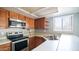 Well-lit kitchen featuring modern appliances and double basin stainless steel sink at 1432 W Emerald Ave # 712, Mesa, AZ 85202