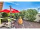 Inviting backyard featuring desert landscaping, patio seating, umbrella, and shaded areas at 14385 W Morning Star Trl, Surprise, AZ 85374