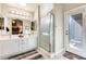 Well-lit bathroom featuring double sinks, modern fixtures, and a walk-in shower with glass door at 14385 W Morning Star Trl, Surprise, AZ 85374